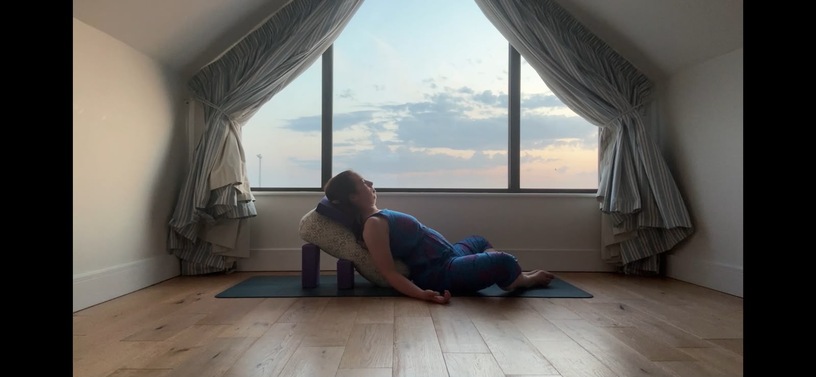 Supported restorative yoga with bolster